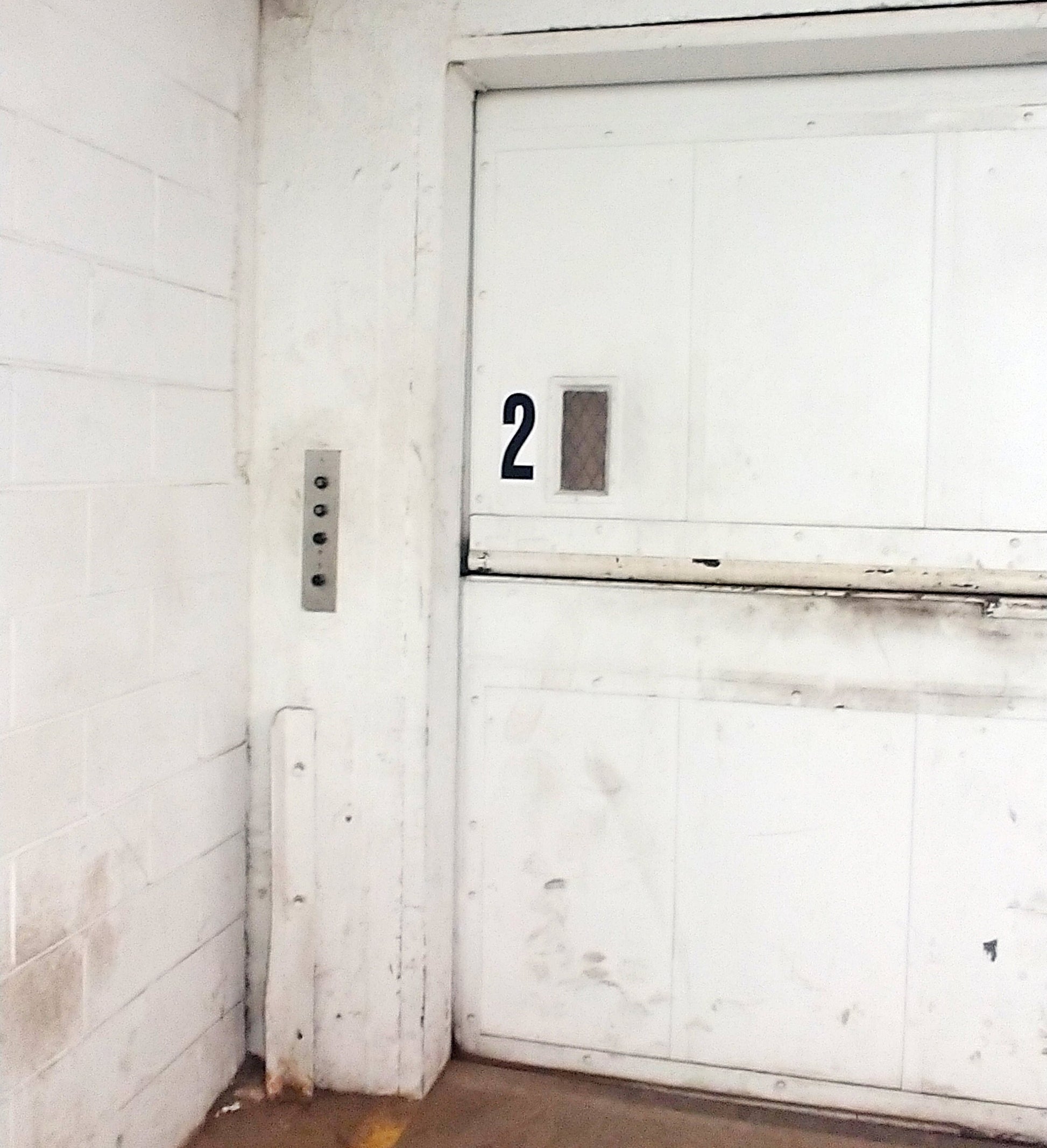 The number 2 printed as a 9 inch tall decal from the Stikons product line by InkBird Print Studio. Applied to an elevator door to indicate that you are on currently on floor 2.