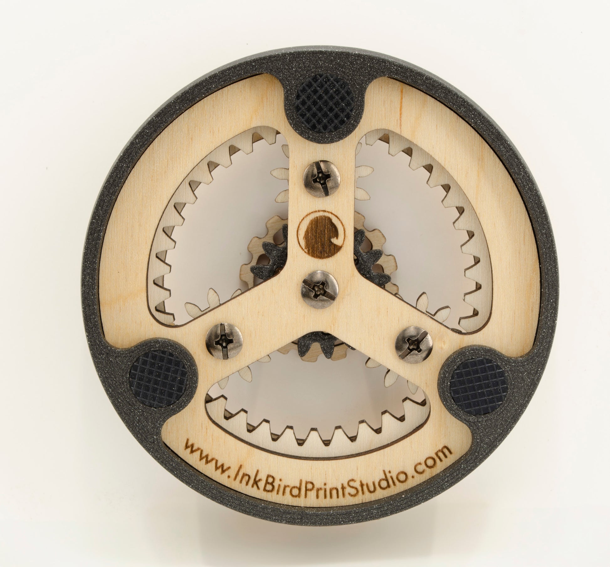 The back of the dishwasher magnet, featuring a wooden frame with a 3D-printed PLA outer ring. Three rubberized feet are embedded in the frame to prevent scratches and provide grip on metal surfaces. The central wooden piece is secured with small screws and has a laser-engraved swirl logo. The website 'www.InkBirdPrintStudio.com' is engraved along the bottom edge, adding a branded touch.