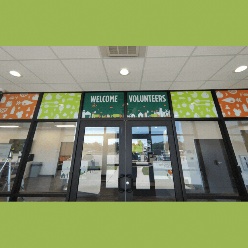 A photo of the lobby windows at Forgotten Harvest. Installed by InkBird Print Studio. Decals welcome and thank their volunteers