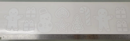 The Holiday Cookie Static Cling Set by InkBird Print Studio LLC features a collection of cookie cutter designs such as a gingerbread man, snowman, heart, star, Christmas tree, and candy cane. It's perfect for creating festive window decorations and includes gift box designs. A ruler at the bottom helps indicate the scale of these renter-friendly winter window clings.