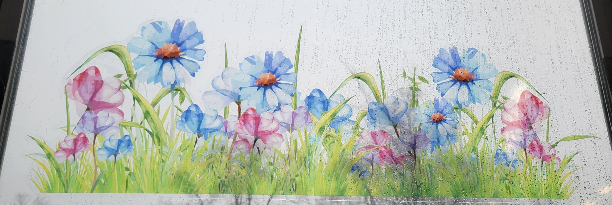 decorative floral design of a meadow, static cling, applied to a rainy window. Blues and pinks, stained glass or watercolor vibes