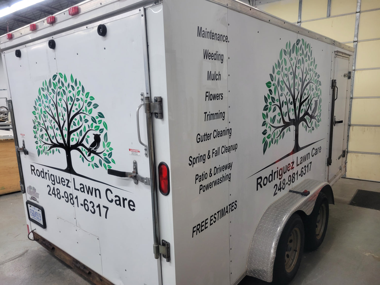 Custom Applied Vinyl to a lawn care trailer. Multiple colors, black text. Designed and Installed by InkBird Print Studio