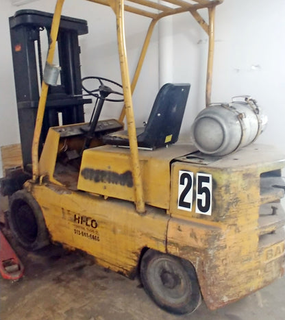 The numbers 2 and 5 printed as 12 inch tall stikons decals, applied to the side of a forklift for warehouse labelling and tracking. 