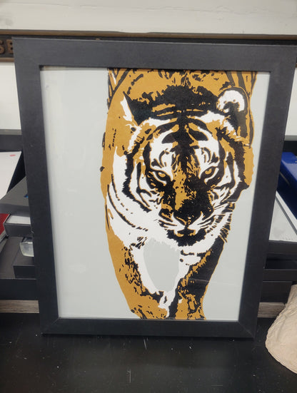 "Tiger I" a 3-color screen print by Claire Davis featuring a stylized tiger in bold, vibrant colors. 8x10 print, shown here in a simple black frame. 
Original photo, digital design, and printmaking by Claire Davis