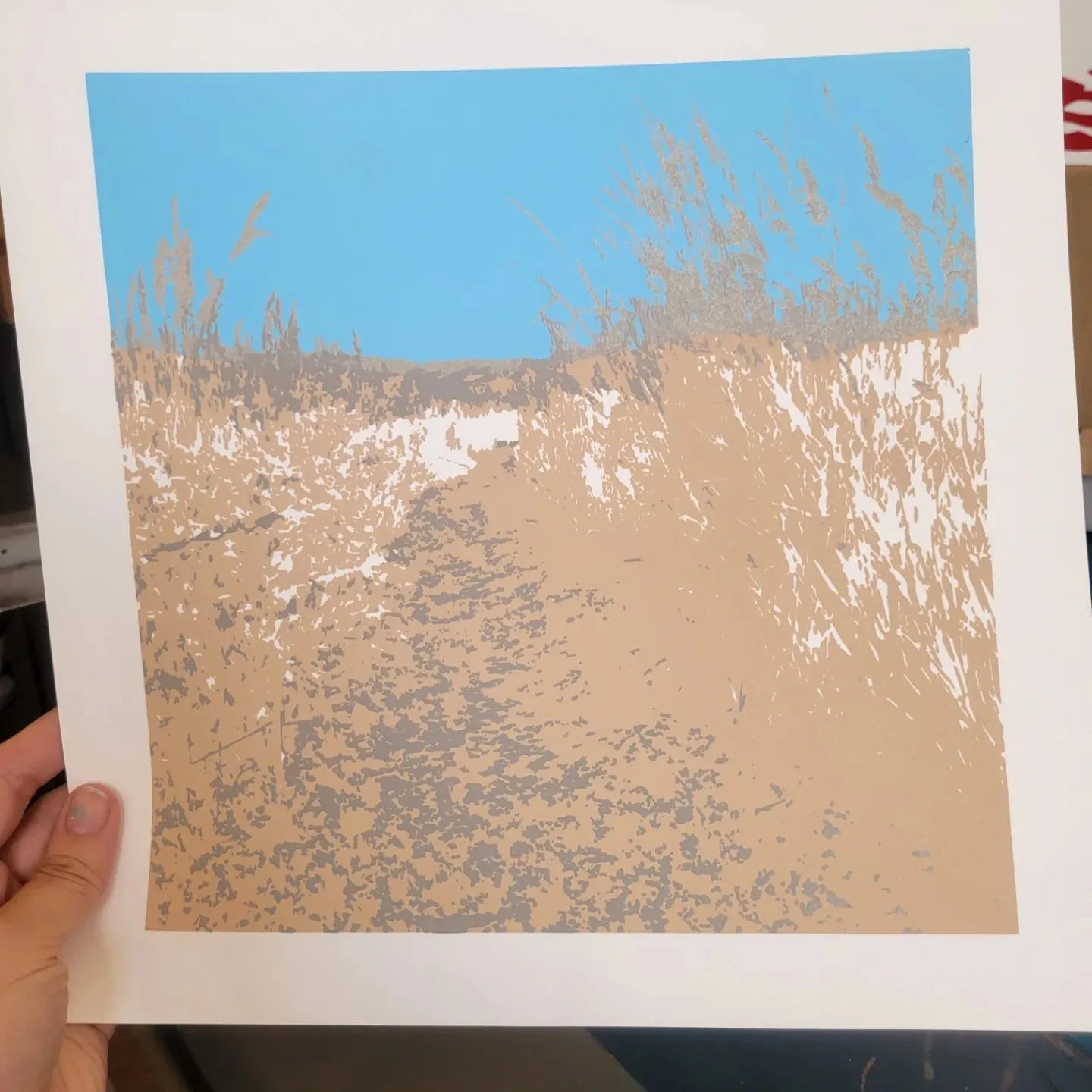 A process photo of the printing of "Picture Rock Trail", a 6 color screenprint by InkBird Print Studio. Original photo by Claire Davis. This photo shows the print after the 3rd color has been applied.