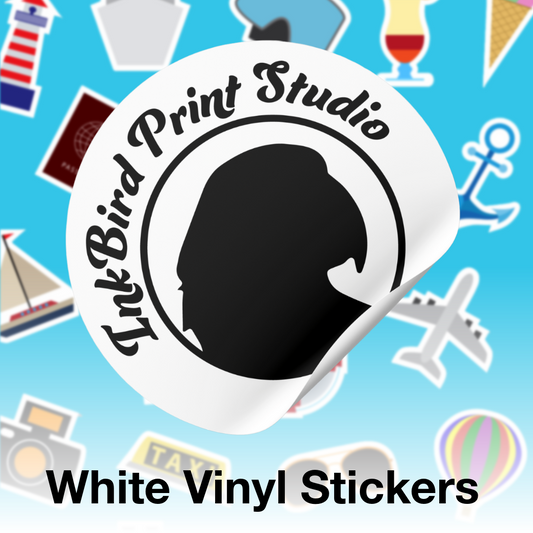 A white vinyl sticker shown on a blue background with scattered travel-themed stickers around it. The main sticker has a black silhouette profile and the text 'InkBird Print Studio.