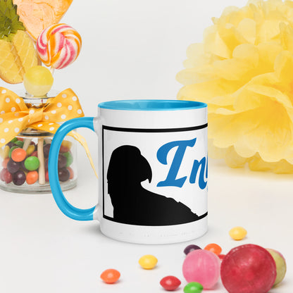 The InkBird Print Studio LLC's "InkBird Print Studio Logo Mug with Color Inside" features a blue handle and a black silhouette with "In" in blue text, surrounded by colorful candies and a yellow flower decoration. Next to it, a jar adorned with a yellow polka dot ribbon overflows with lollipops and multi-colored sweets. This dishwasher-safe mug enhances the vibrant, colorful design.